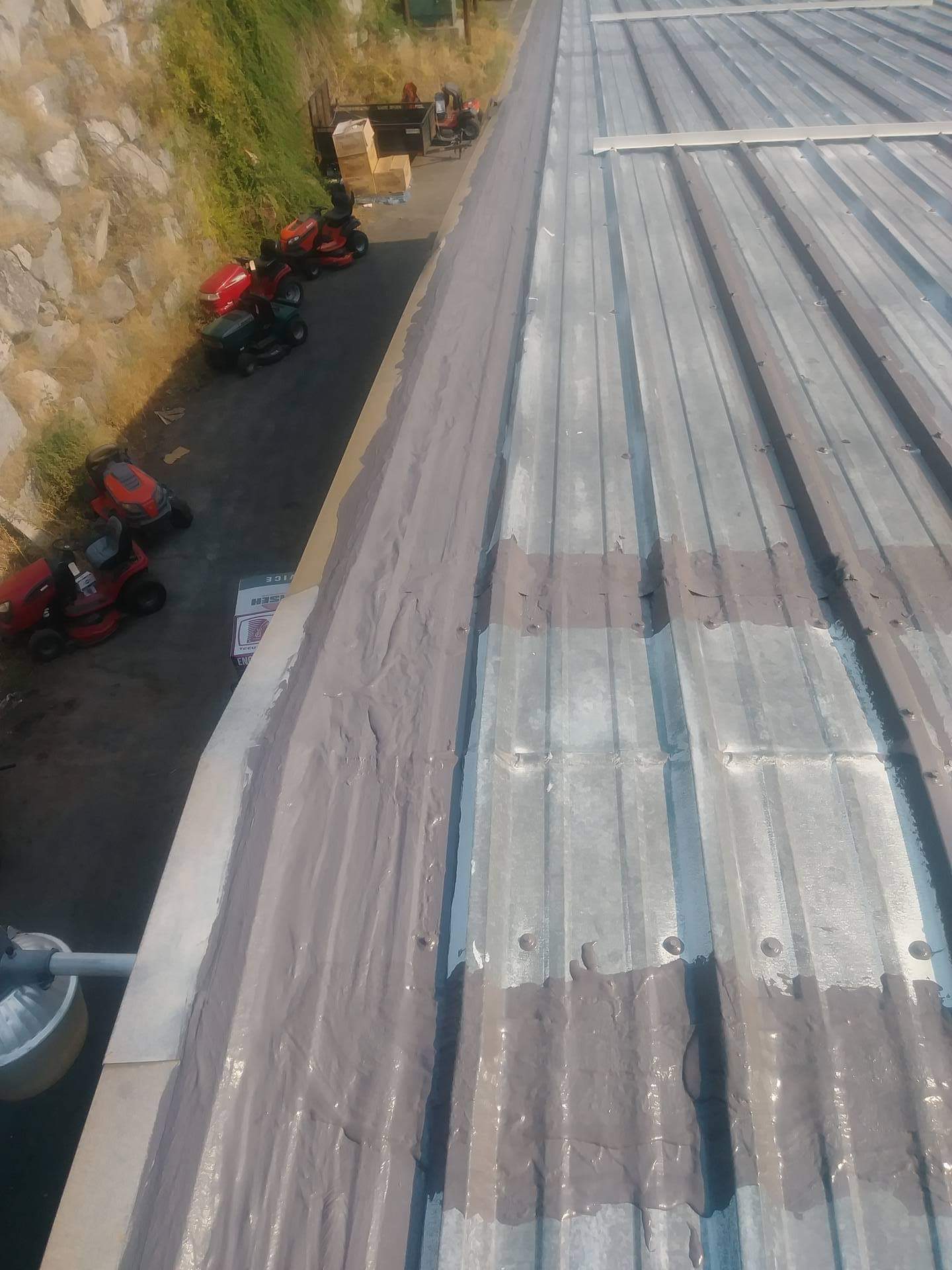 Roof edge coating detail on corrugated metal panels