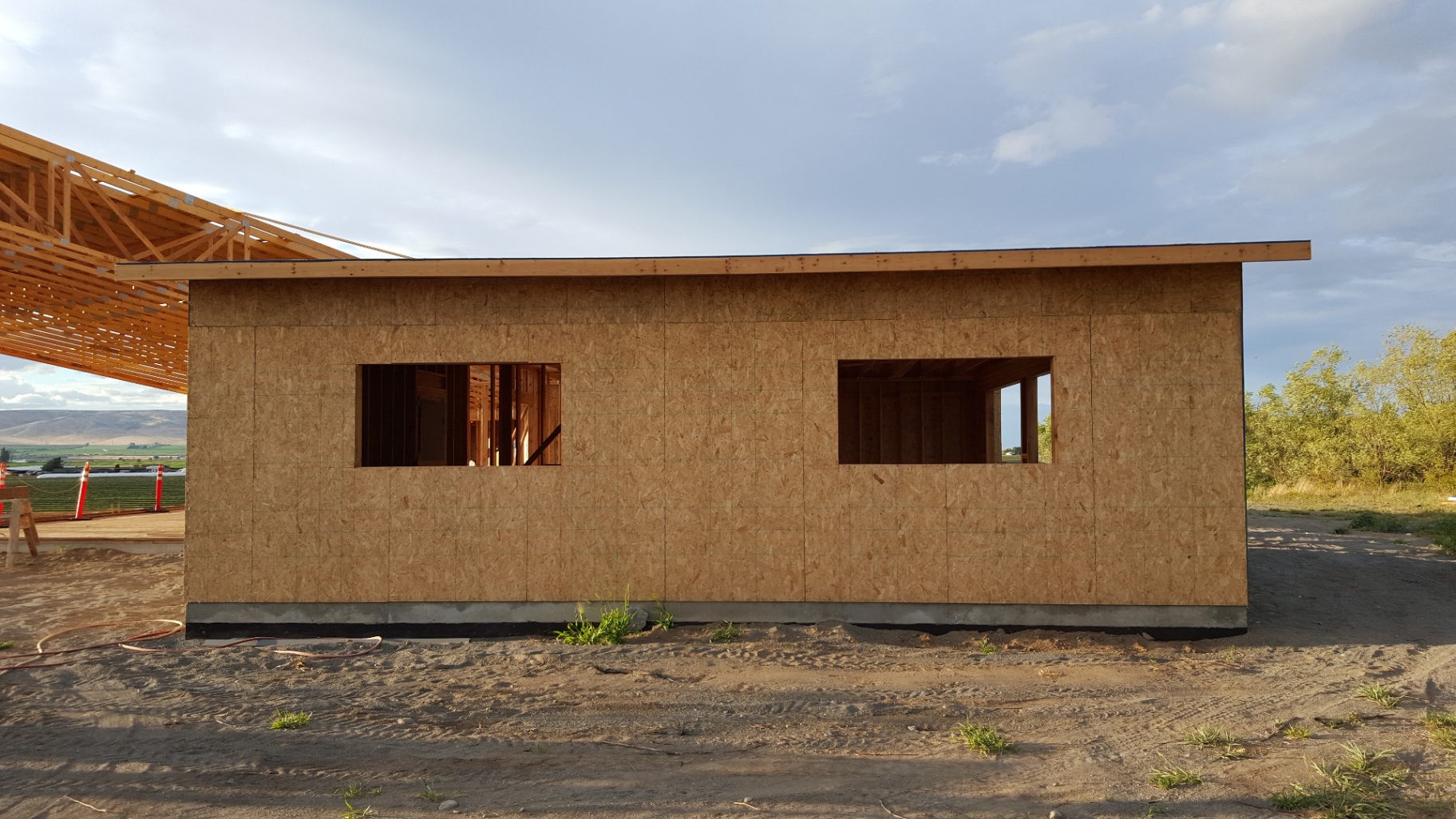 Side wall sheathed with windows roughed in