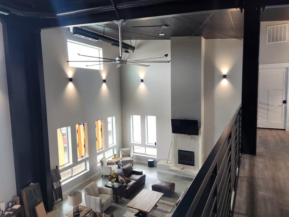 Custom home — upstairs view of two-story living room with fireplace and tall windows