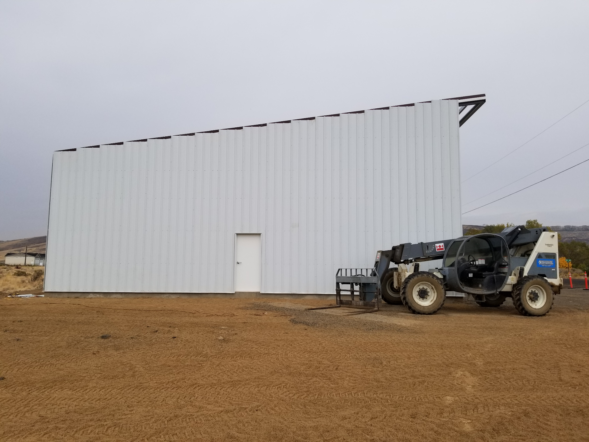Steel building exterior wall panels going on
