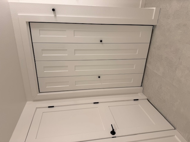 Bathroom remodel — white shaker bi-fold closet doors with matte black hardware